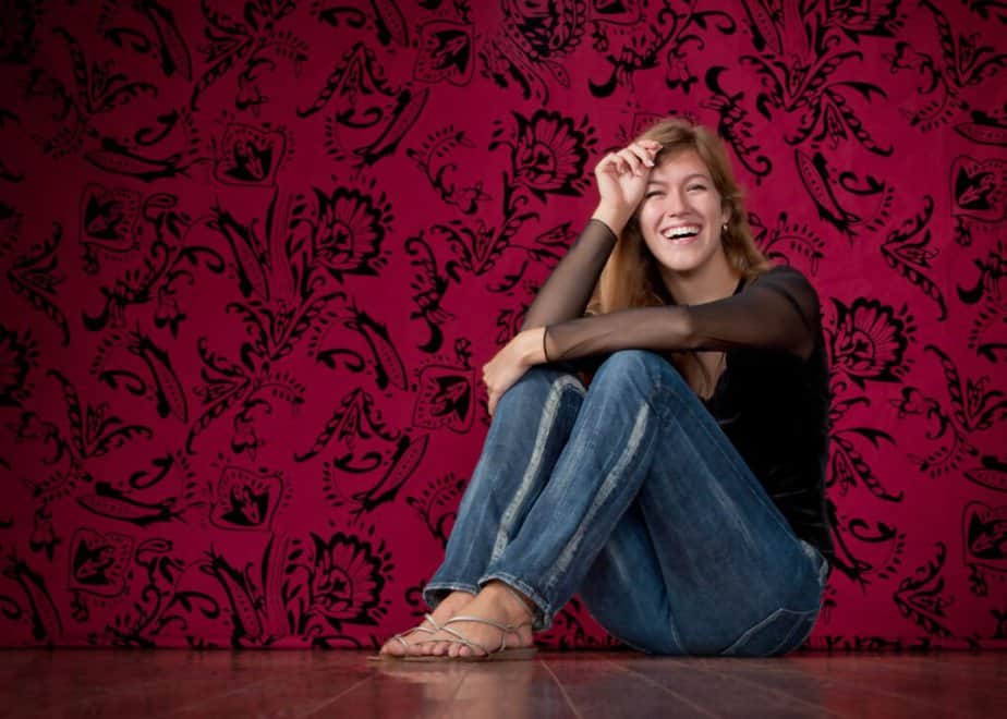 High school senior portrait against a red damask studio backdrop